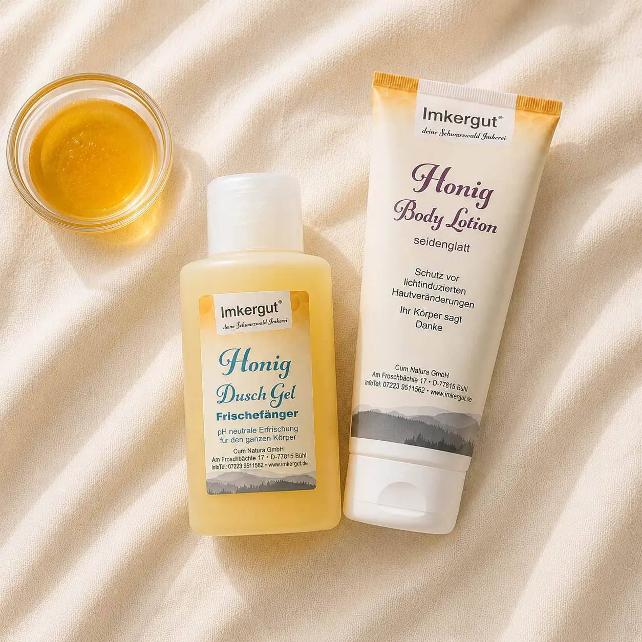 Honey body lotion and shower balm on a light towel