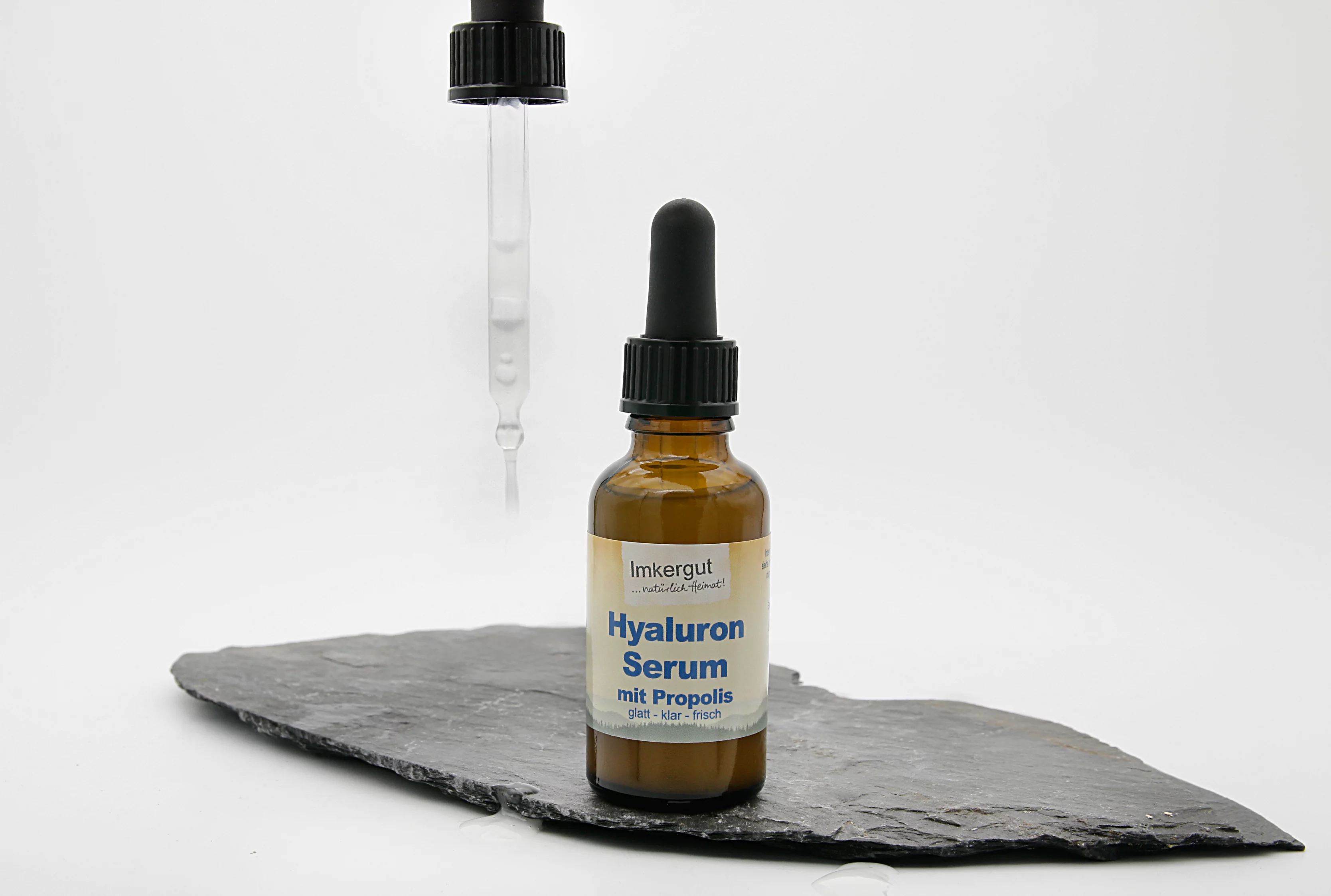 Hyaluron Serum neben Pipette auf Schieferplatte